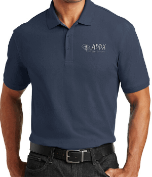 Man wearing a navy blue polo shirt with the logo "APPX Staff Favorite" on the left chest, paired with black jeans and a black belt.