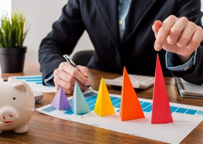 Businessman With Colorful Cones Representing Growth