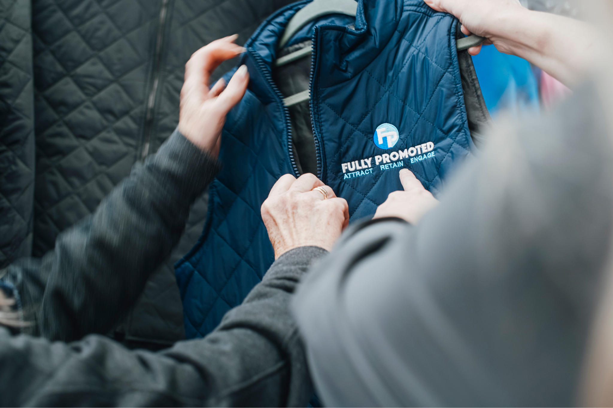 A row of clothing hangers displays polo shirts in various colors, including red, blue, green, white, and purple—perfect for showcasing your franchise's success.